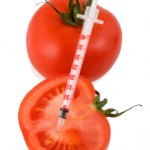 tomato with hypodermic needle stuck in it