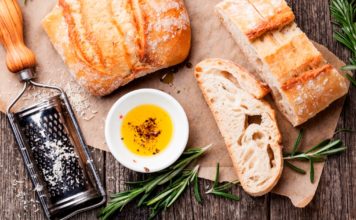 Sliced bread Ciabatta and extra virgin Olive oil on wooden background