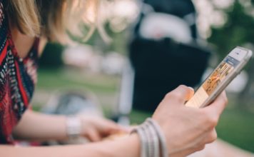 Close up side view of a woman using a cell phone