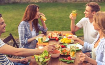 people eating outside at a table