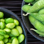 Edamame soy beans shelled and with pods in bowls