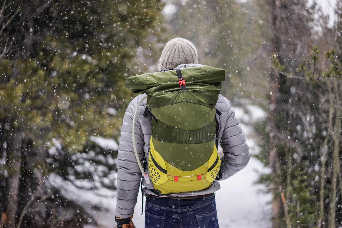 man with hiking gear walking in snow