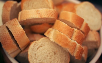 sliced french bread in a white bowl