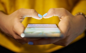 close up of woman hands and smart phone