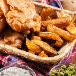 101720936 – traditional fish in beer batter and chips served on basket