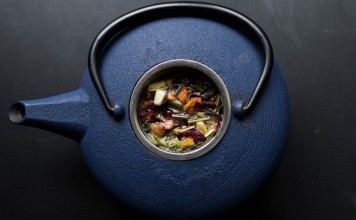 Herbs inside a blue tea kettle