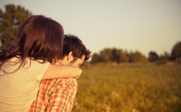 Did You Know… Love Really Does Heal the Body? woman getting a piggy-back ride in an amber field