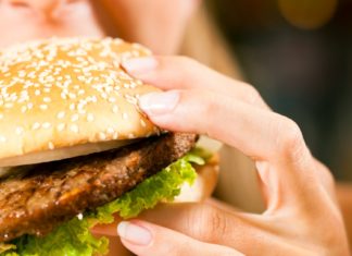 High-Protein Diet Linked to Heart Failure Risk in Older Women woman eating a hamburger
