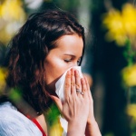 Woman Holding tissue to her nose