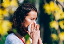 Woman Holding tissue to her nose