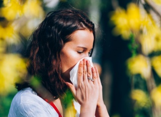 Woman Holding tissue to her nose