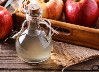 Three Researched Health Benefits of Apple Cider Vinegar carafe of apple cider and red apples